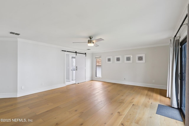 1823 N Lakeshore Dr, Fleming Island, FL 32003 - empty room featuring ceiling fan, light wood-style flooring, a barn door, and crown molding