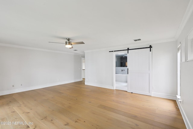 1823 N Lakeshore Dr, Fleming Island, FL 32003 - unfurnished bedroom featuring a barn door, ornamental molding, and light wood-style floors