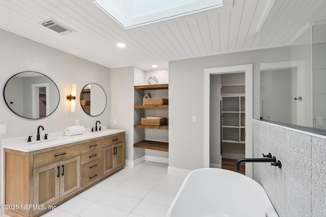 1823 N Lakeshore Dr, Fleming Island, FL 32003 - full bathroom featuring a skylight, a freestanding bath, double vanity, tile patterned flooring, and wooden ceiling