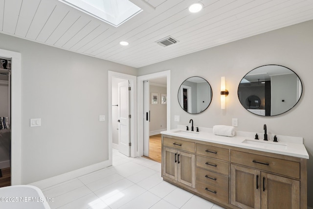 1823 N Lakeshore Dr, Fleming Island, FL 32003 - bathroom with a skylight, double vanity, tile patterned floors, recessed lighting, and wood ceiling