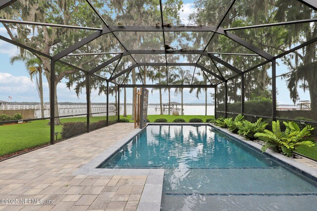 1823 N Lakeshore Dr, Fleming Island, FL 32003 - view of swimming pool with a yard, a patio area, glass enclosure, and a water view