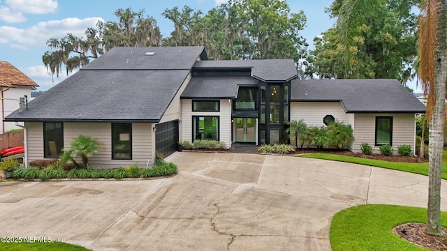 1823 N Lakeshore Dr, Fleming Island, FL 32003 - view of front facade featuring curved driveway, roof with shingles, and french doors
