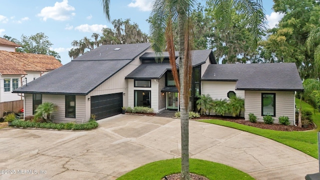 1823 N Lakeshore Dr, Fleming Island, FL 32003 - view of front of home with driveway, an attached garage, and roof with shingles
