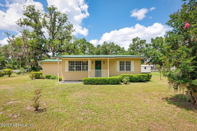 37206 Cypress Ln, Hilliard, FL 32046 - ranch-style home featuring a front yard, a porch, and a metal roof