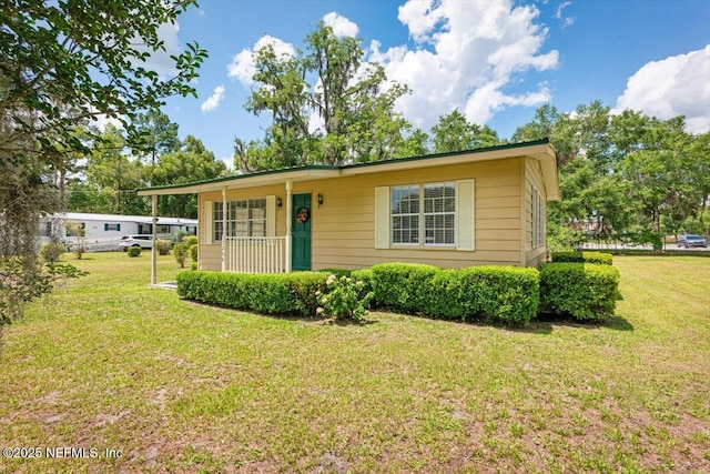 37206 Cypress Ln, Hilliard, FL 32046 - view of front of house featuring a front yard and a porch