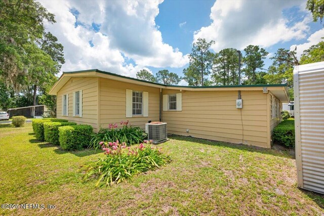 37206 Cypress Ln, Hilliard, FL 32046 - back of house featuring a lawn