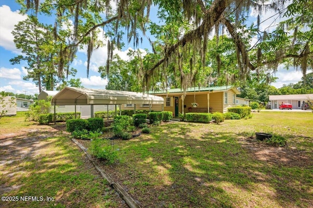 37206 Cypress Ln, Hilliard, FL 32046 - view of grassy yard with a carport and a porch