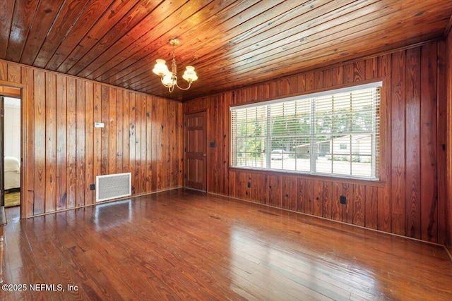 37206 Cypress Ln, Hilliard, FL 32046 - unfurnished room with a chandelier, hardwood / wood-style floors, wooden walls, and wood ceiling