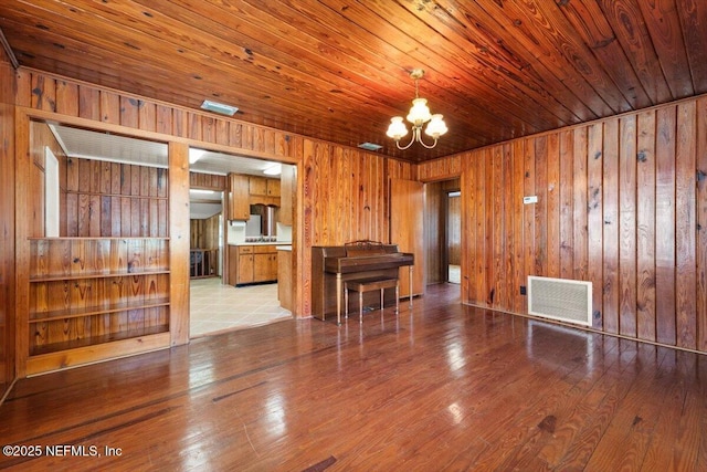 37206 Cypress Ln, Hilliard, FL 32046 - living room with wooden walls, a chandelier, hardwood / wood-style floors, and wood ceiling