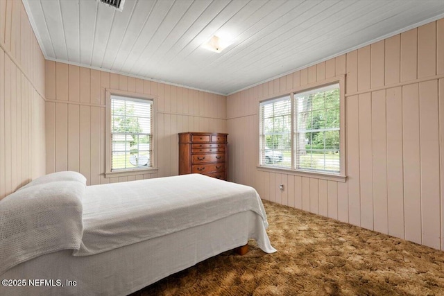 37206 Cypress Ln, Hilliard, FL 32046 - carpeted bedroom featuring multiple windows and wooden walls