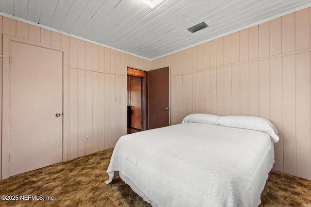 37206 Cypress Ln, Hilliard, FL 32046 - bedroom featuring carpet flooring, ornamental molding, wood walls, and a closet