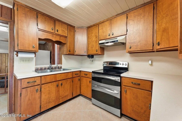 37206 Cypress Ln, Hilliard, FL 32046 - kitchen featuring under cabinet range hood, double oven range, and brown cabinetry