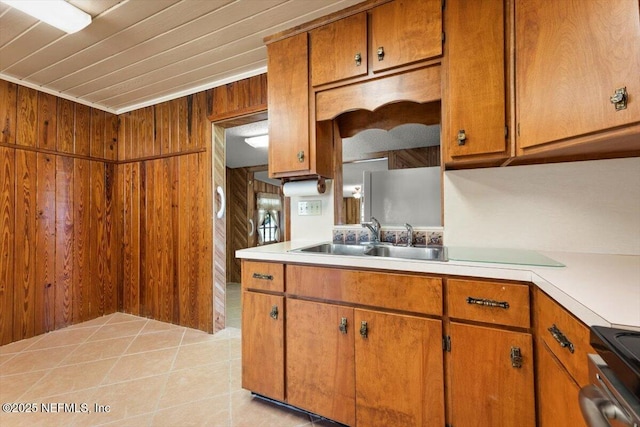 37206 Cypress Ln, Hilliard, FL 32046 - kitchen with brown cabinets, wooden walls, light countertops, black range with electric stovetop, and light tile patterned floors