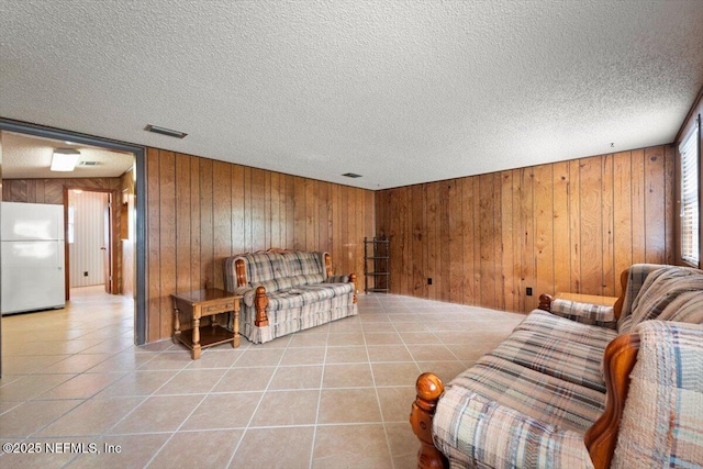 37206 Cypress Ln, Hilliard, FL 32046 - living room with wood walls, light tile patterned floors, and a textured ceiling