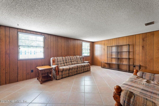 37206 Cypress Ln, Hilliard, FL 32046 - living area featuring wood walls, a textured ceiling, and tile patterned floors