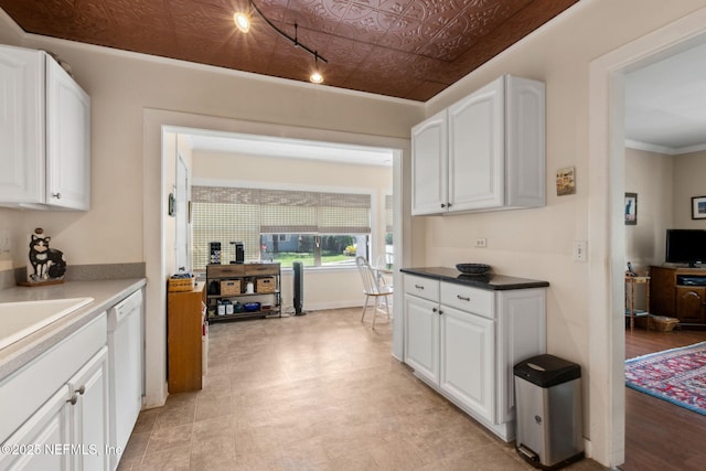 112 S 14th St, Fernandina Beach, FL 32034 - kitchen with white cabinetry, rail lighting, dishwasher, and an ornate ceiling