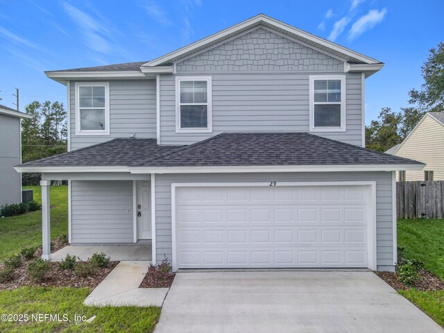 29 Wood Ash Ln, Palm Coast, FL 32164 - traditional-style house with roof with shingles, driveway, and an attached garage