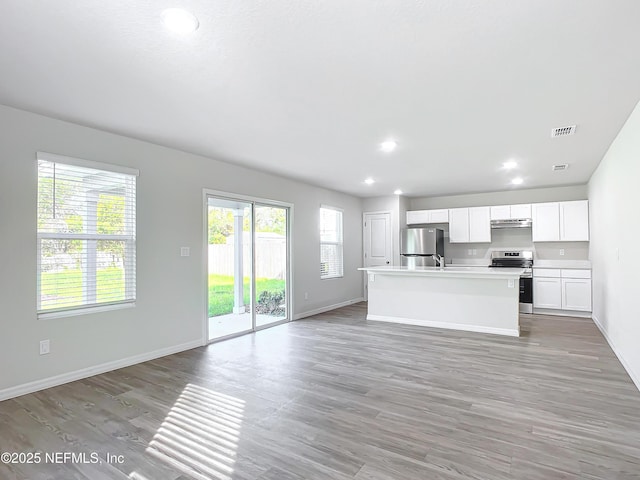 29 Wood Ash Ln, Palm Coast, FL 32164 - unfurnished living room featuring light wood finished floors and recessed lighting