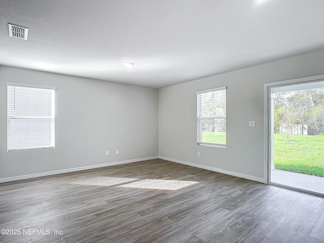 29 Wood Ash Ln, Palm Coast, FL 32164 - empty room with wood finished floors and baseboards