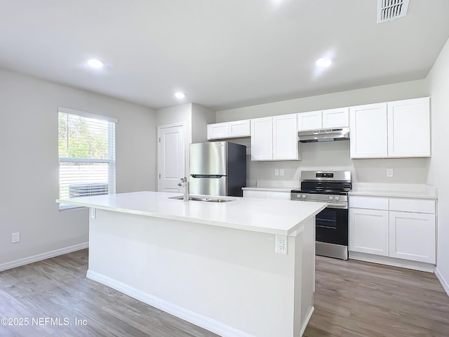 29 Wood Ash Ln, Palm Coast, FL 32164 - kitchen featuring appliances with stainless steel finishes, under cabinet range hood, white cabinets, and recessed lighting
