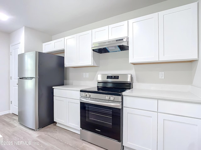 29 Wood Ash Ln, Palm Coast, FL 32164 - kitchen featuring appliances with stainless steel finishes, under cabinet range hood, light wood finished floors, and white cabinetry