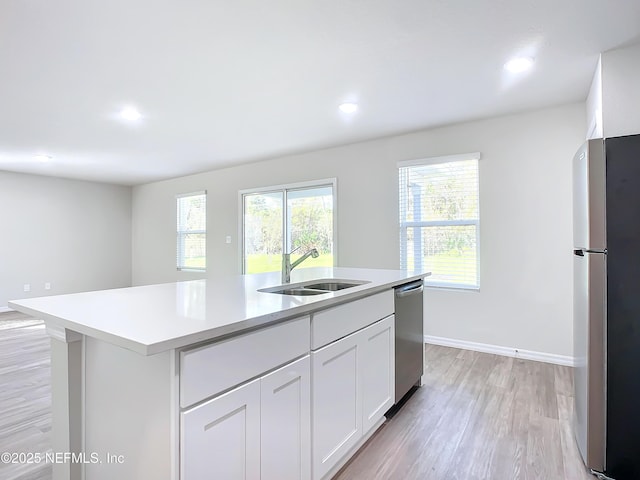 29 Wood Ash Ln, Palm Coast, FL 32164 - kitchen with appliances with stainless steel finishes, light countertops, light wood-style floors, healthy amount of natural light, and recessed lighting