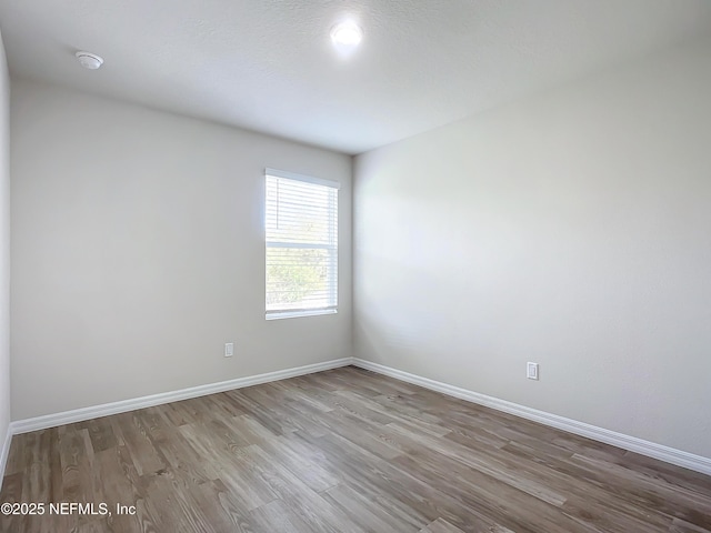 29 Wood Ash Ln, Palm Coast, FL 32164 - empty room with wood finished floors and a smoke detector