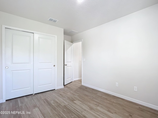 29 Wood Ash Ln, Palm Coast, FL 32164 - unfurnished bedroom featuring light wood-type flooring and a closet