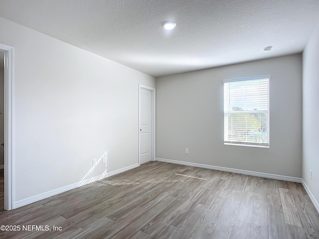29 Wood Ash Ln, Palm Coast, FL 32164 - unfurnished room featuring wood finished floors, a textured ceiling, and a smoke detector