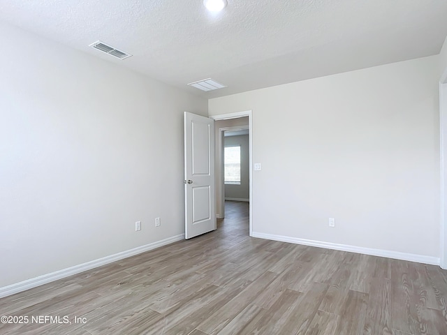 29 Wood Ash Ln, Palm Coast, FL 32164 - spare room featuring light wood-style floors and a textured ceiling