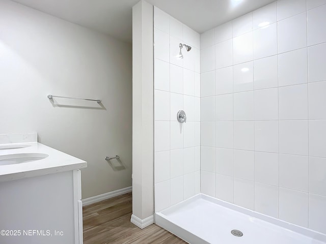 29 Wood Ash Ln, Palm Coast, FL 32164 - full bath featuring a tile shower, wood finished floors, and vanity