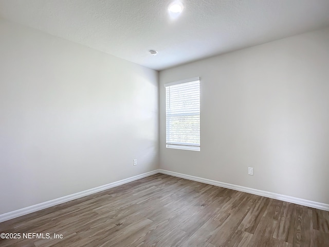 29 Wood Ash Ln, Palm Coast, FL 32164 - empty room featuring wood finished floors and baseboards