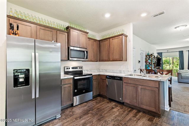 81 Scotch Pebble Dr, Saint Augustine, FL 32259 - kitchen featuring stainless steel appliances, open floor plan, a peninsula, and dark wood-style floors