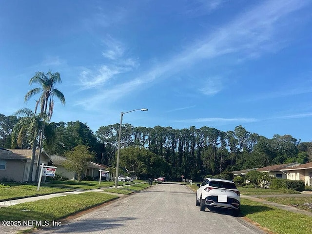 819 Helmsman Way, Palm Harbor, FL 34685 - view of asphalt street with sidewalks, street lights, curbs, and a residential view