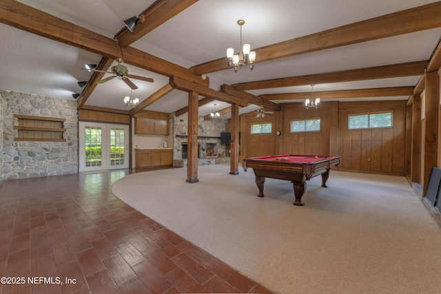 5042 Brighton Dr, Jacksonville, FL 32217 - recreation room featuring healthy amount of natural light, a chandelier, a stone fireplace, billiards table, and wooden walls