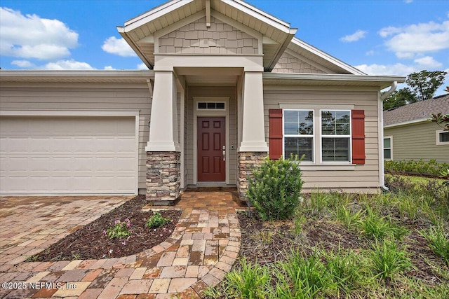 619 Brown Bear Run, Saint Johns, FL 32259 - view of front of house with decorative driveway, a garage, and stone siding