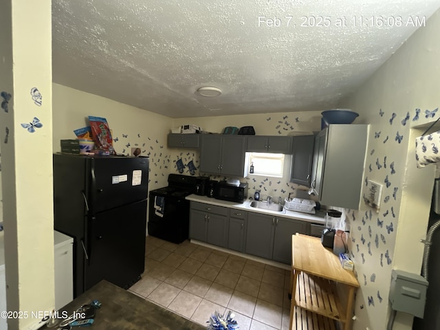 1417 Logan St Unit 1417-1419, Jacksonville, FL 32209 - kitchen featuring black appliances, gray cabinetry, a textured ceiling, light tile patterned floors, and light countertops