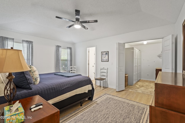1853 Weston Cir, Fleming Island, FL 32003 - bedroom featuring light wood-style flooring, a textured ceiling, and a ceiling fan
