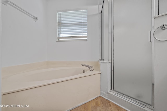 1853 Weston Cir, Fleming Island, FL 32003 - full bathroom featuring a shower stall, a garden tub, and wood finished floors