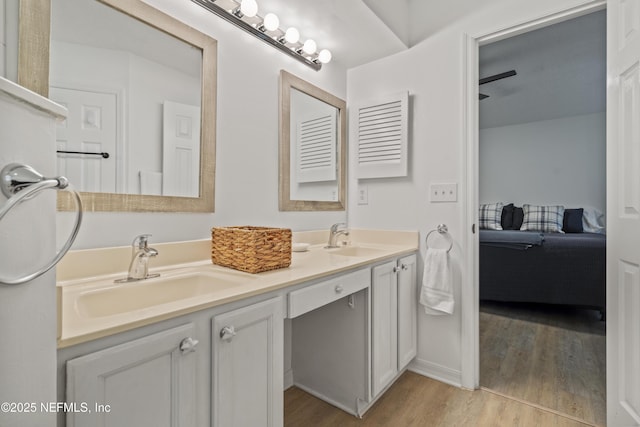 1853 Weston Cir, Fleming Island, FL 32003 - full bath featuring connected bathroom, double vanity, and wood finished floors