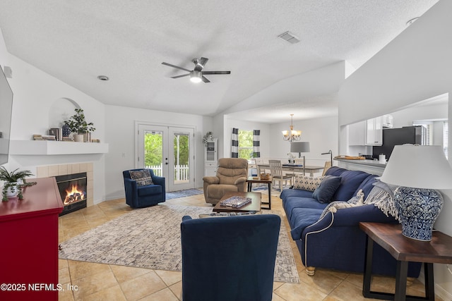 1853 Weston Cir, Fleming Island, FL 32003 - living area with vaulted ceiling, ceiling fan, light tile patterned floors, a chandelier, and a textured ceiling