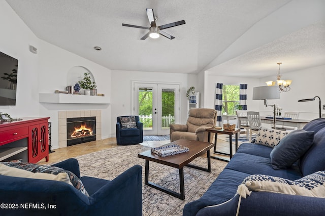 1853 Weston Cir, Fleming Island, FL 32003 - tiled living area with vaulted ceiling, plenty of natural light, a textured ceiling, ceiling fan, and a tiled fireplace