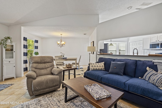 1853 Weston Cir, Fleming Island, FL 32003 - living room with a textured ceiling, a chandelier, lofted ceiling, and light tile patterned floors