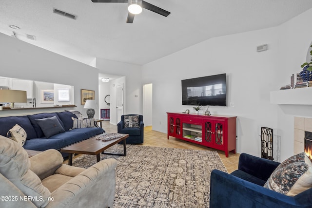 1853 Weston Cir, Fleming Island, FL 32003 - living area with vaulted ceiling, a ceiling fan, and a tile fireplace