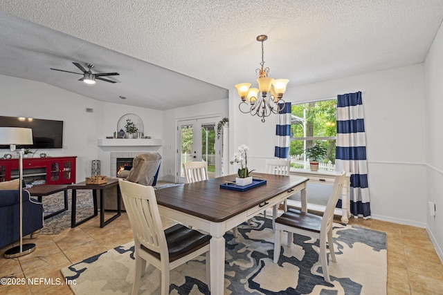 1853 Weston Cir, Fleming Island, FL 32003 - dining area with light tile patterned floors, a fireplace, a chandelier, healthy amount of natural light, and a textured ceiling
