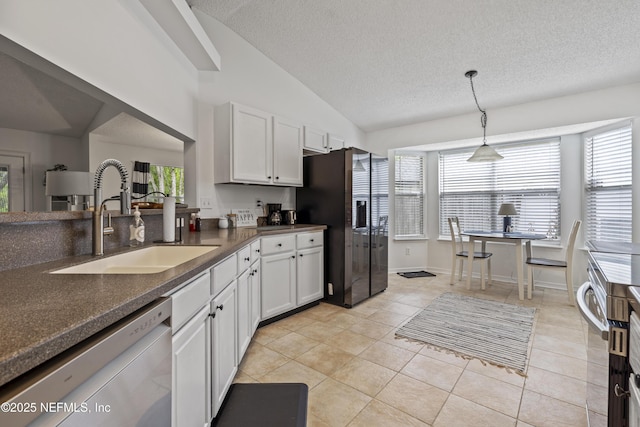 1853 Weston Cir, Fleming Island, FL 32003 - kitchen with appliances with stainless steel finishes, dark countertops, light tile patterned floors, white cabinetry, and pendant lighting
