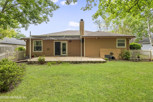 1853 Weston Cir, Fleming Island, FL 32003 - back of house featuring a chimney, a patio area, and french doors
