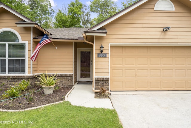1853 Weston Cir, Fleming Island, FL 32003 - view of exterior entry featuring a garage, concrete driveway, and a shingled roof