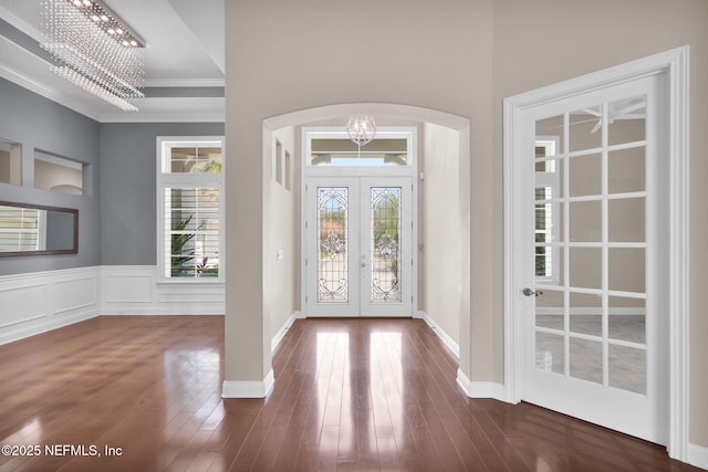 452 Deer Valley Dr, Ponte Vedra, FL 32081 - foyer featuring french doors, arched walkways, a chandelier, crown molding, and dark wood-type flooring