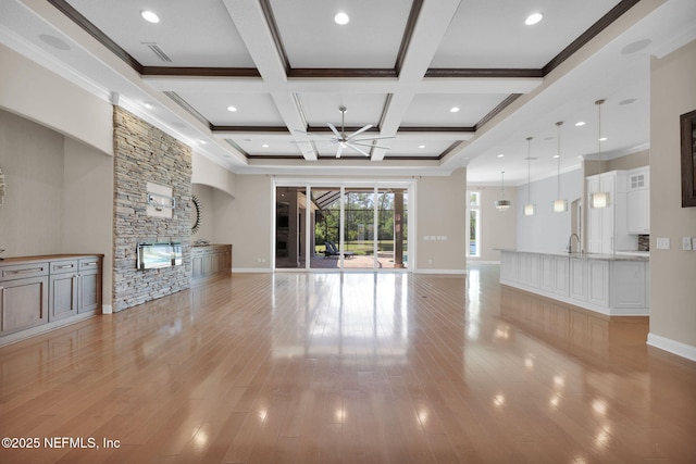 452 Deer Valley Dr, Ponte Vedra, FL 32081 - unfurnished living room featuring ceiling fan, a stone fireplace, beamed ceiling, light wood-type flooring, and coffered ceiling